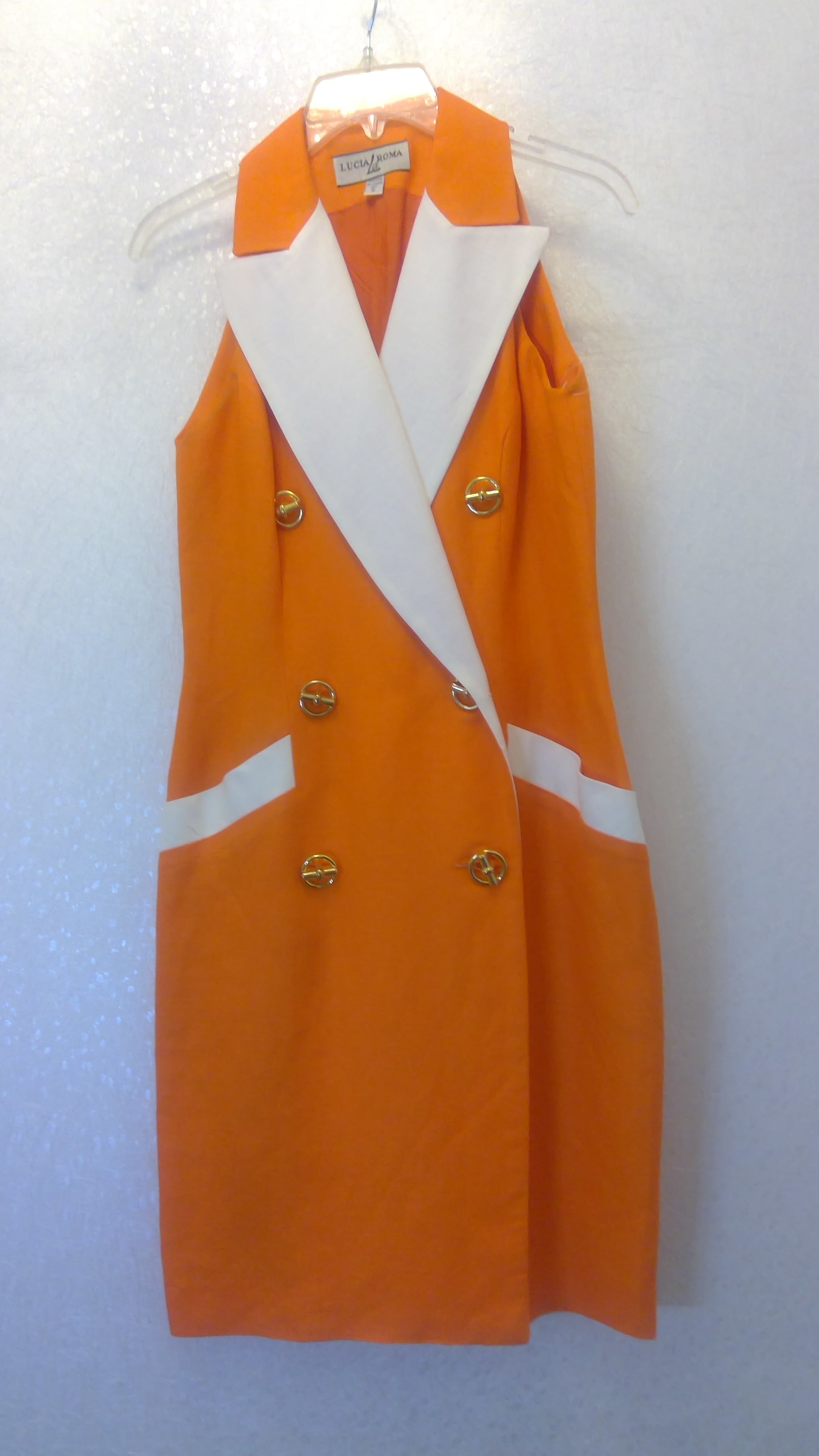 Orange uniform jacket with white accents and gold buttons