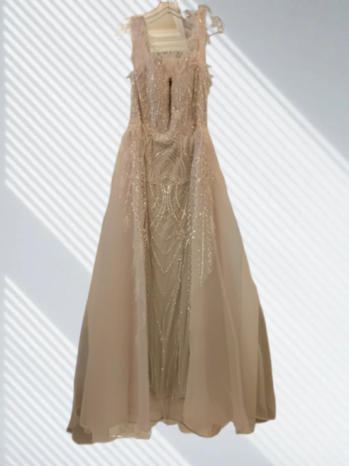 Beige evening gown with intricate detailing
